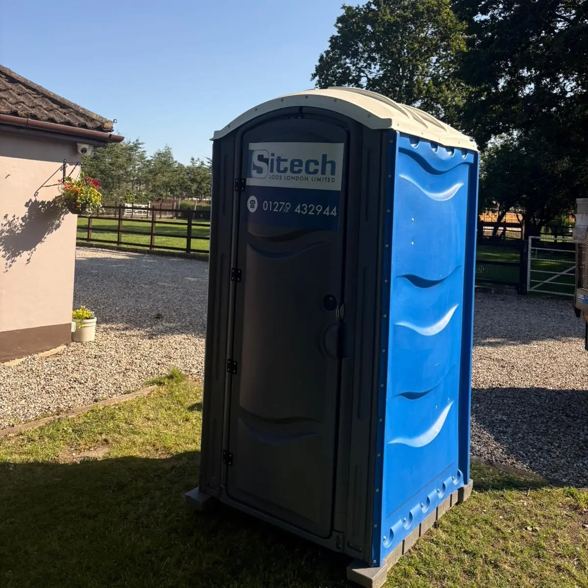 Sitech Loos London branded standard chemical portable toilet sited on a job, available for weekly hire from £32