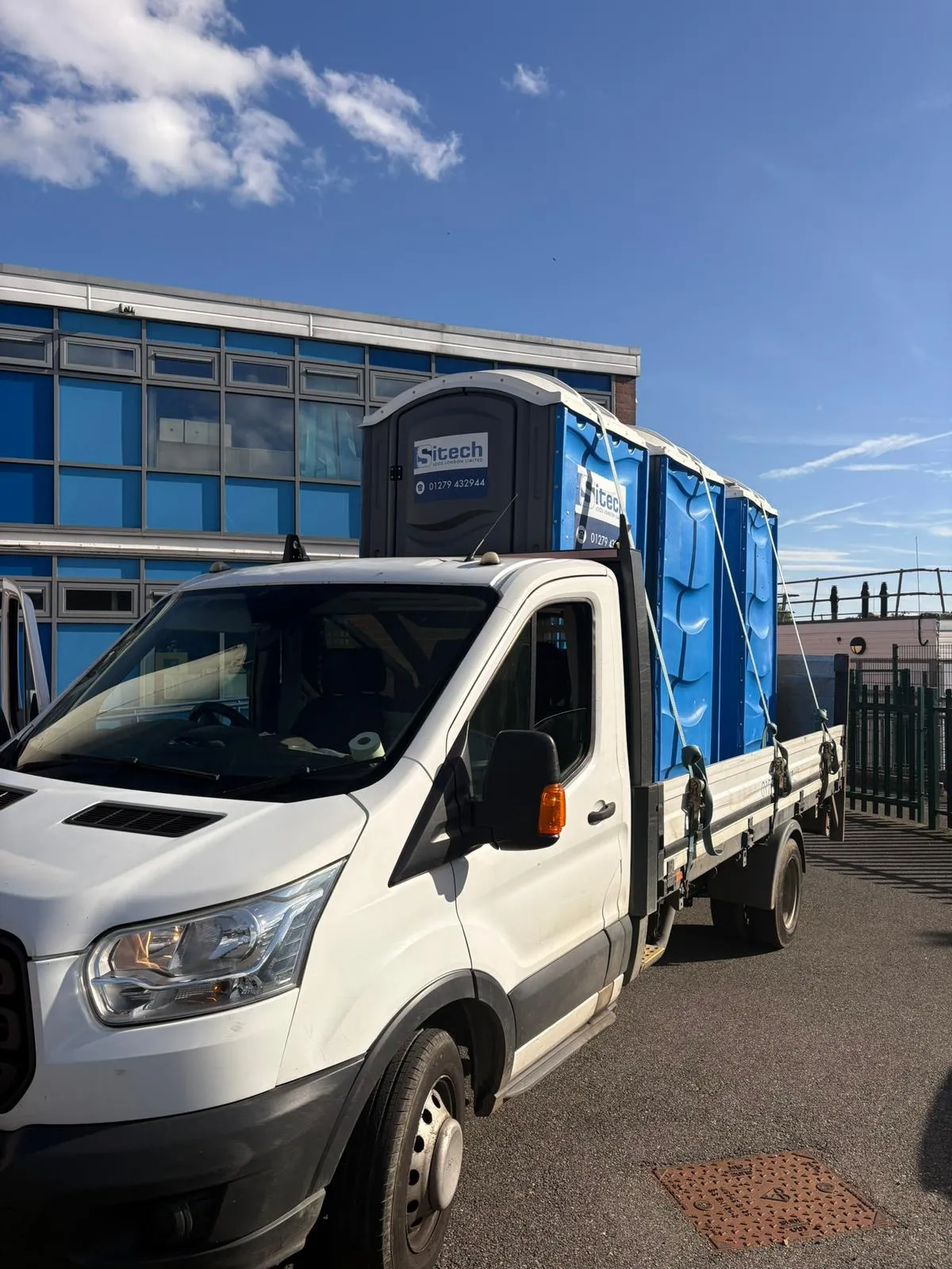Sitech Loos London portable toilets loaded on a delivery vehicle, illustrating the per-job delivery and collection charge that shapes hire cost
