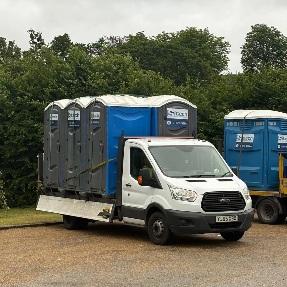 Sitech Loos London delivery truck loaded with temporary portable toilets ready for hire